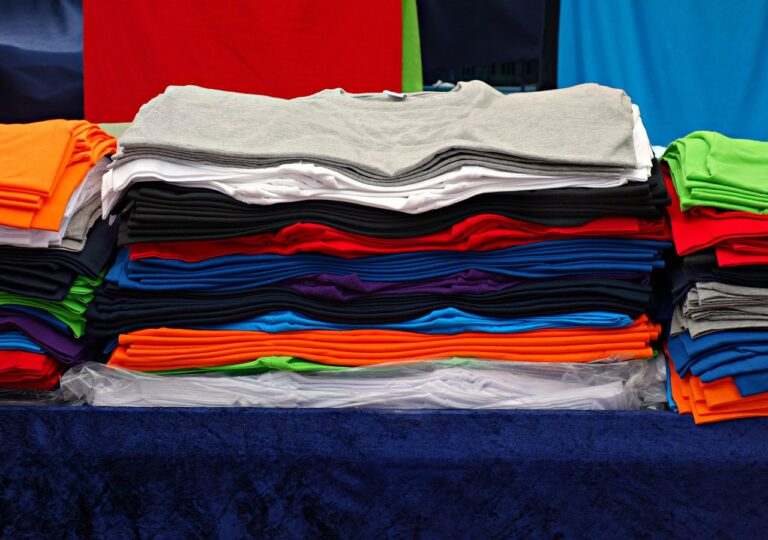 t-shirt, tee, clothing, garment, shirt, fashion, unisex, woman, man, top, casual, pile, pile of t-shirts, market, stall, market stall, t-shirt, t-shirt, t-shirt, t-shirt, t-shirt, shirt, shirt, shirt